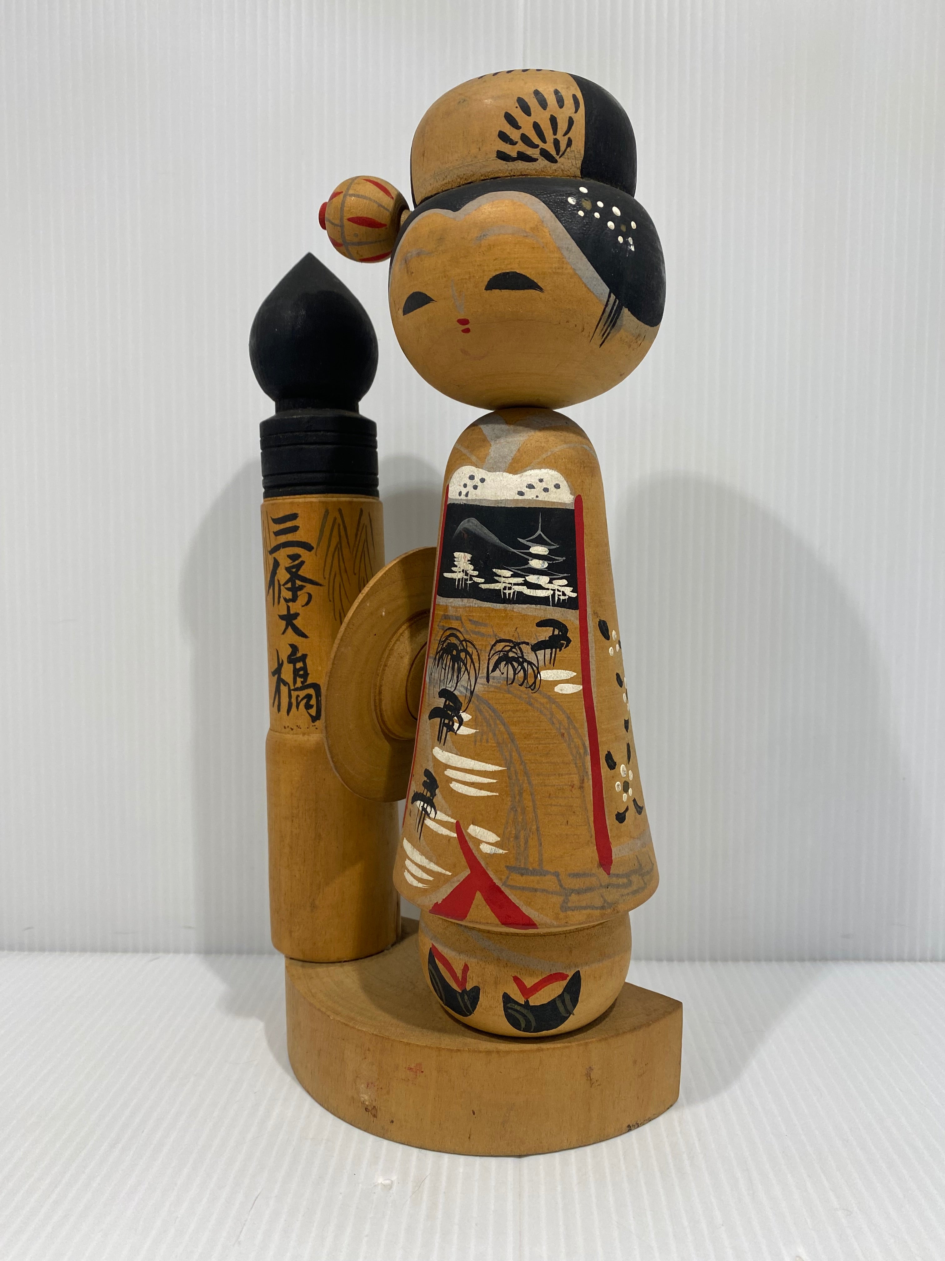Beautiful Vintage Japanese Kokeshi doll with a brush at the side.