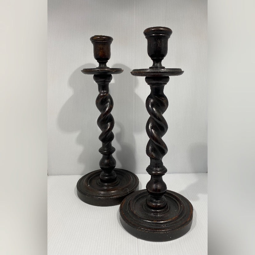 Pair of antique twisted turned wood candlesticks with bronze iron wax catchers and felted base.