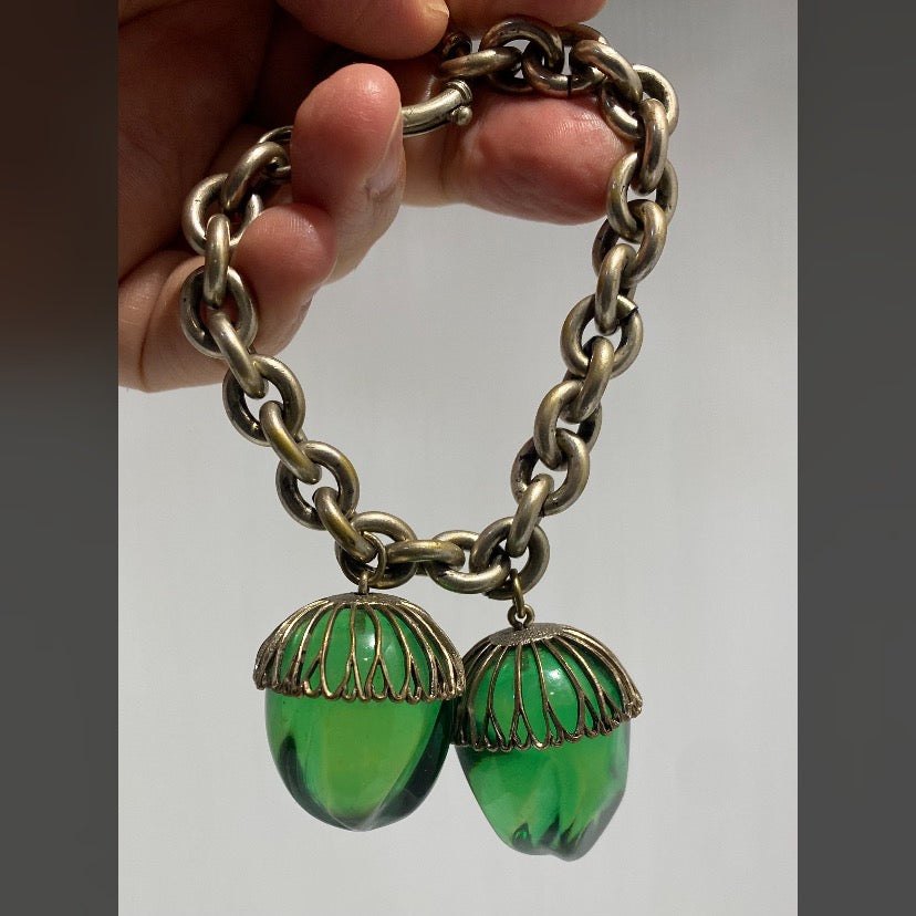 Very rare, vintage white metal bracelet with two green lucite acorn-shaped pendants.