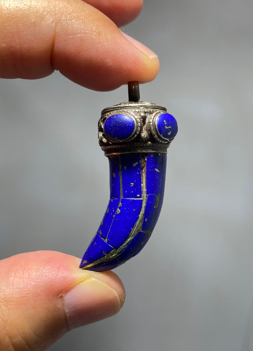 Antique and beautiful, wolf's fang, silver and lapis lazuli lucky charm pendant.