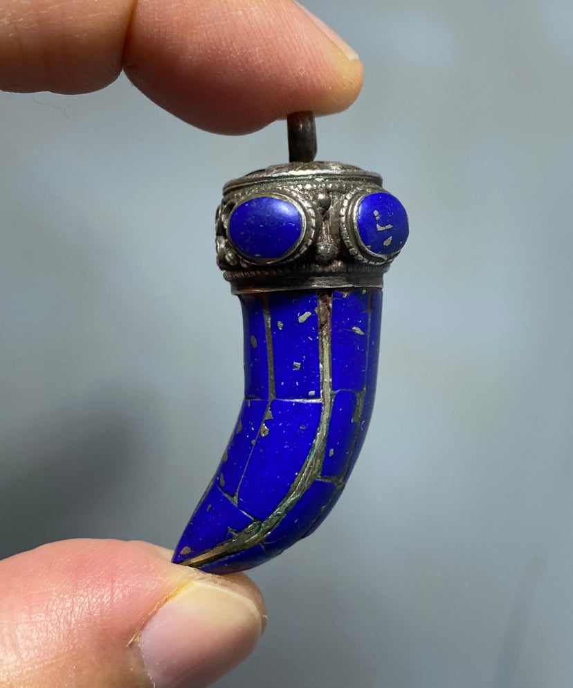 Antique and beautiful, wolf's fang, silver and lapis lazuli lucky charm pendant.