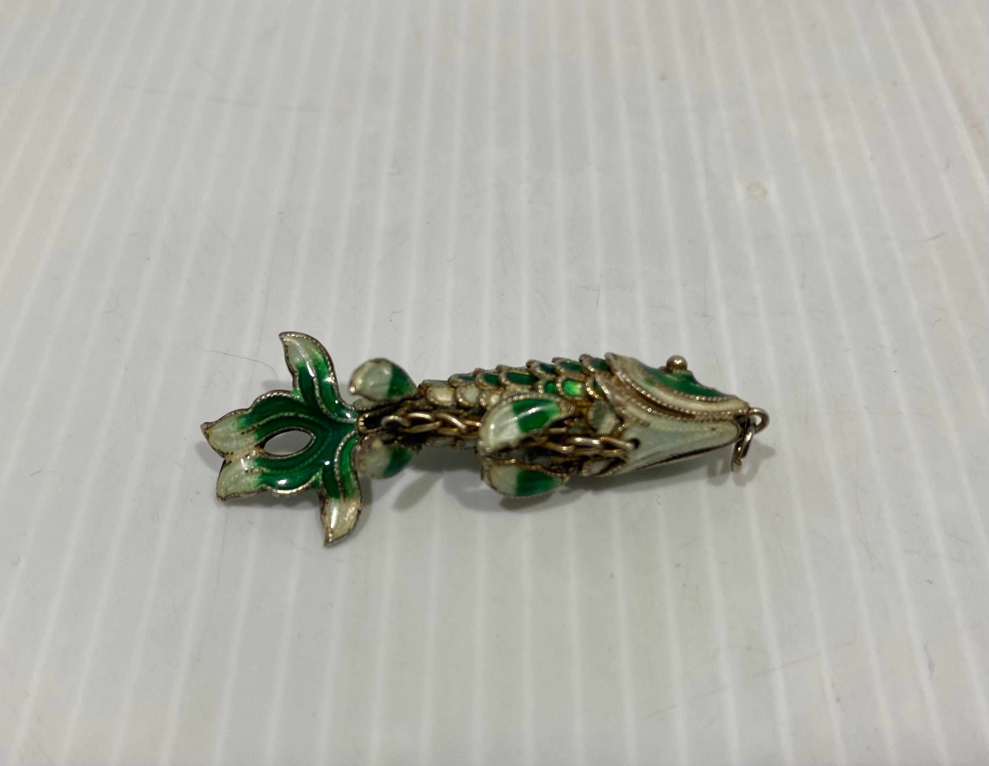 Beautiful, green, vintage articulated enamel fish pendant.
