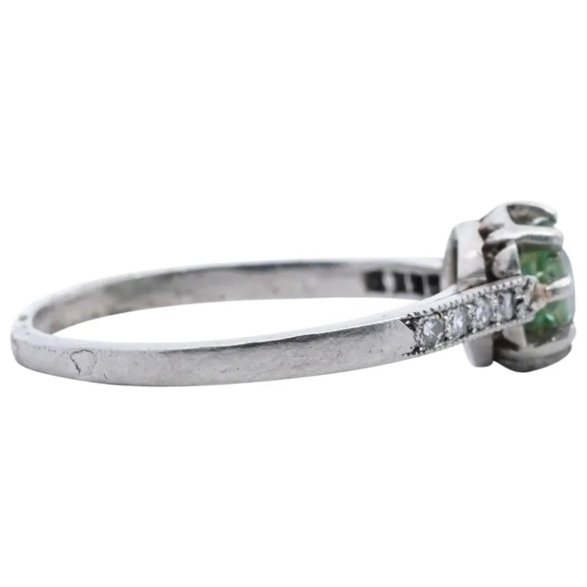 Antique, French 18k white gold ring decorated along the shoulders with diamonds and centered by a brilliant cut Peridot
