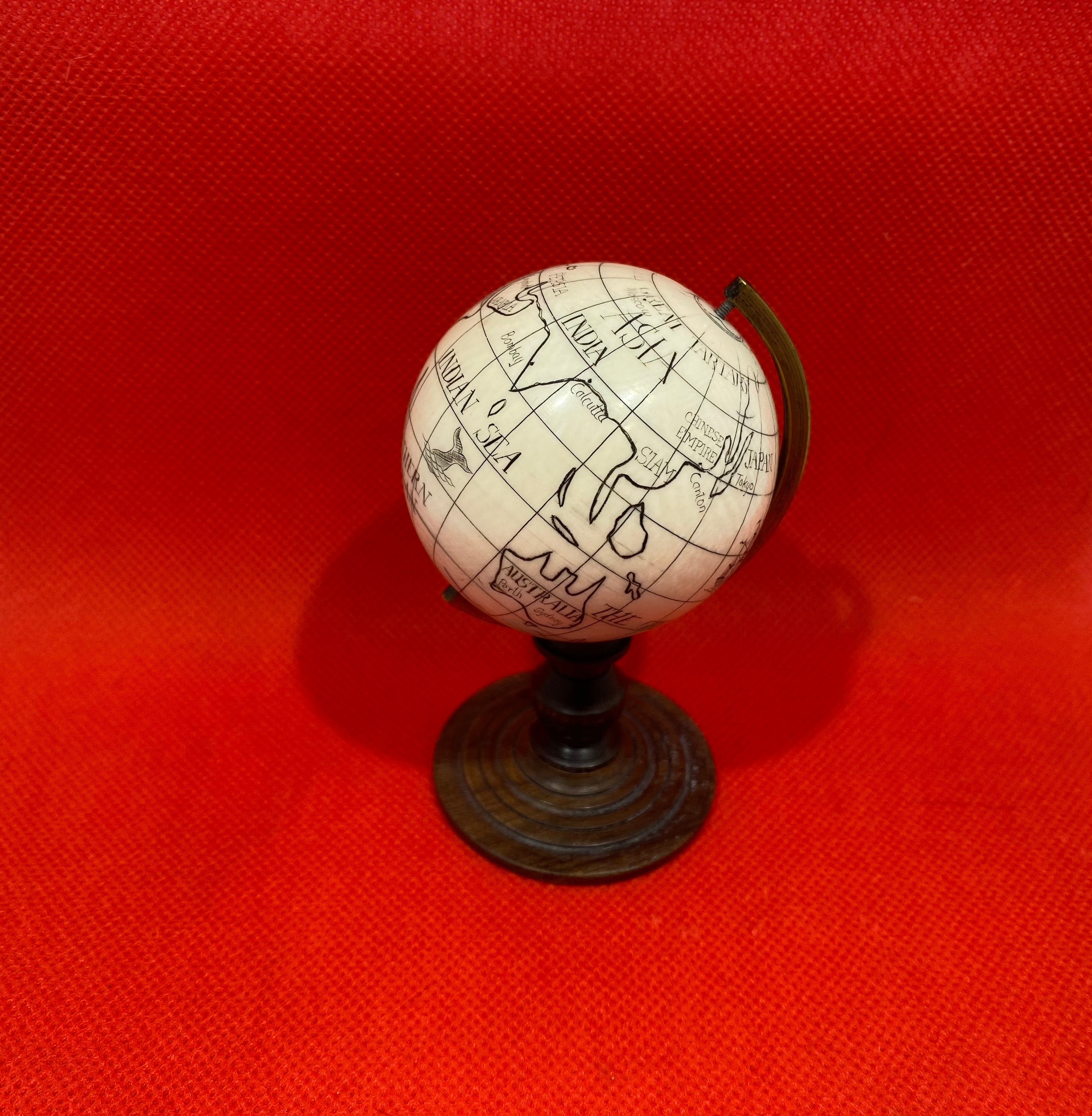 Antique Ivory Scrimshaw orb of a Globe Authentic antique rare 18th-19th century scrimshaw miniature Earth globe mounted in a brass half meridian.
