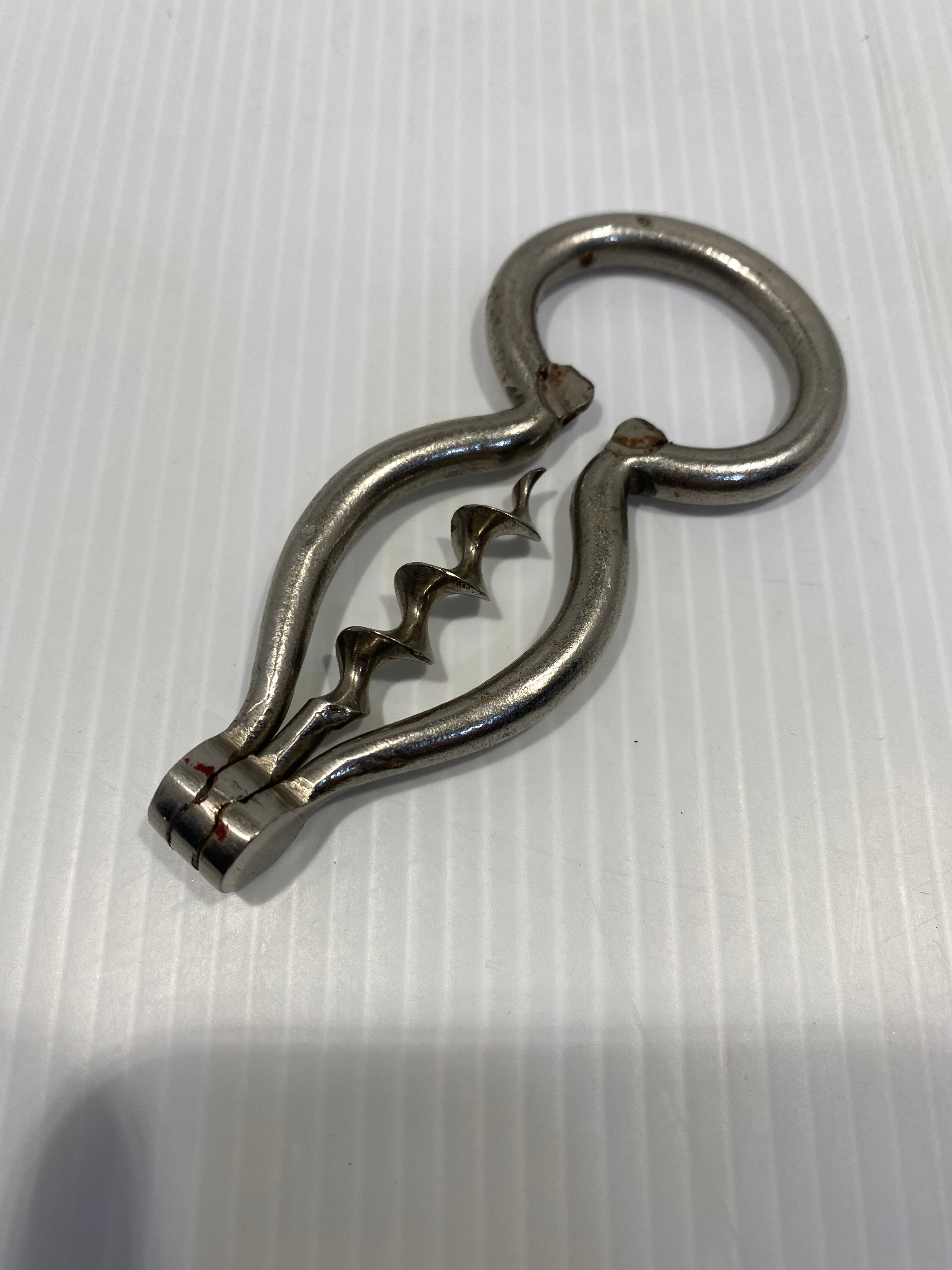 large nickel-plated steel corkscrew, harp type with bottle opener. 19th