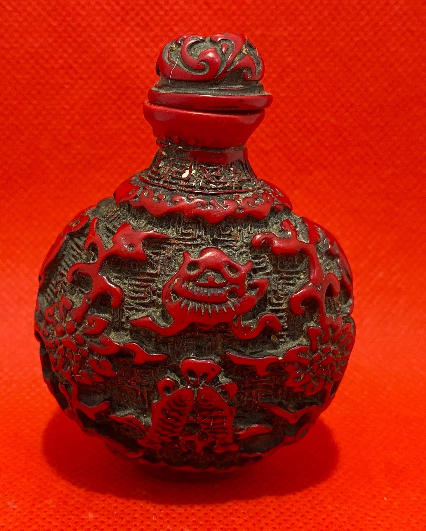 Antique Chinese Cinnabar lacquer snuff bottle, carved with Buddha Symbols. Original stopper. Early 20th century.
