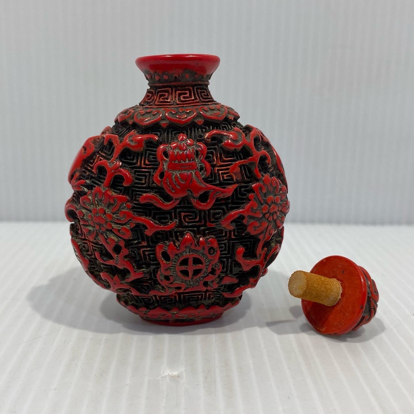 Antique Chinese Cinnabar lacquer snuff bottle, carved  with Buddha Symbols. Original stopper. Early 20th century.
