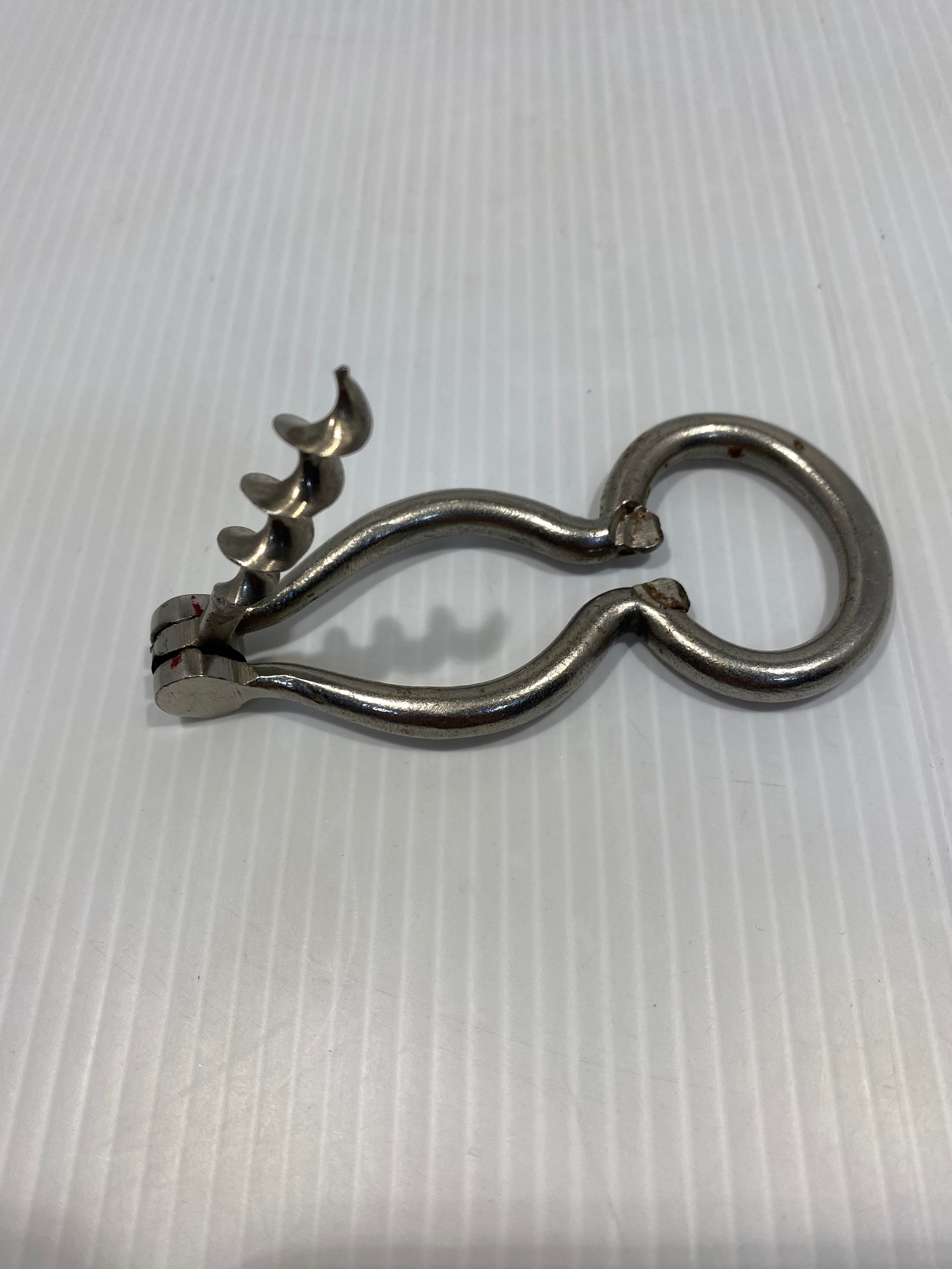 large nickel-plated steel corkscrew, harp type with bottle opener. 19th