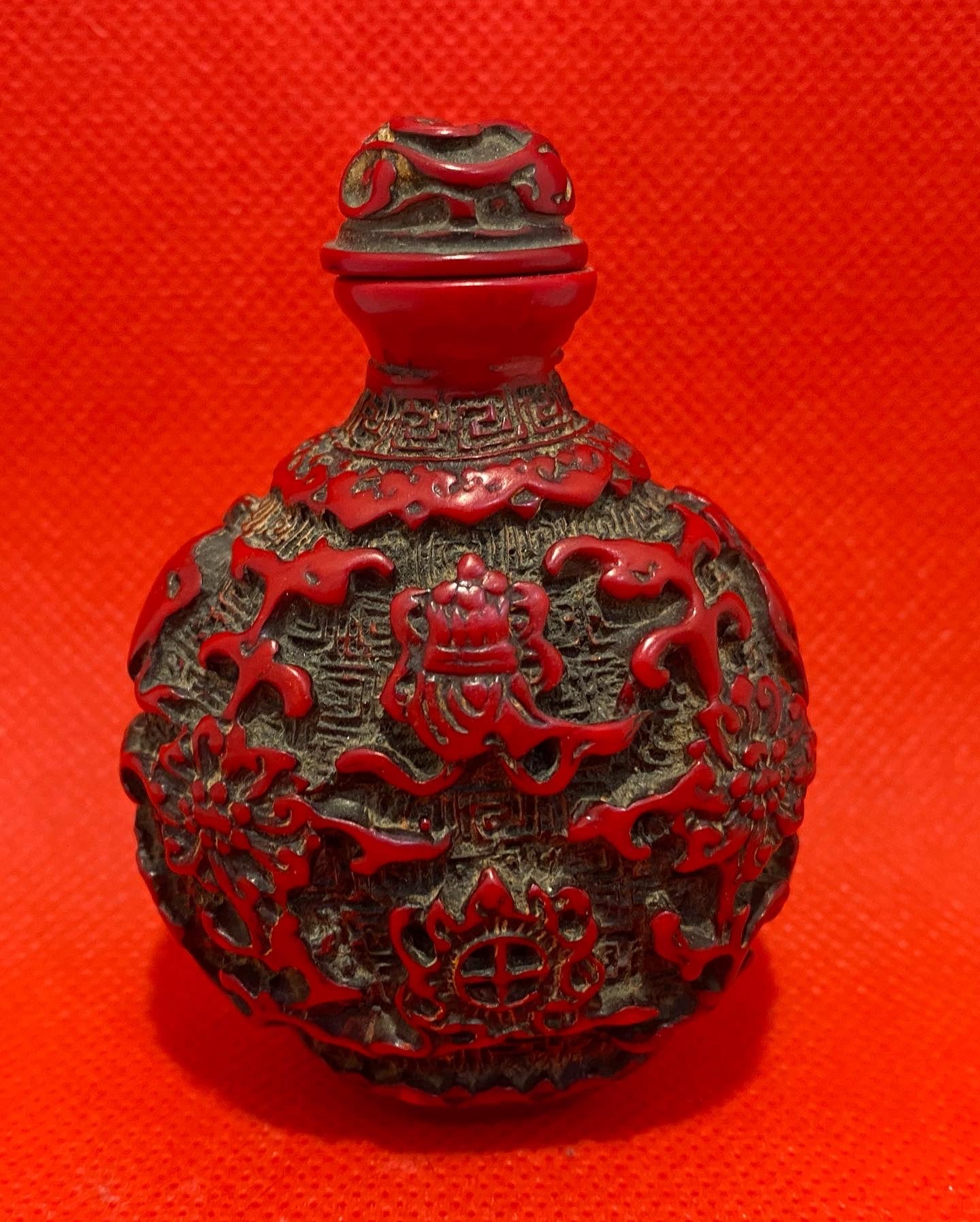 Antique Chinese Cinnabar lacquer snuff bottle, carved with Buddha Symbols. Original stopper. Early 20th century.